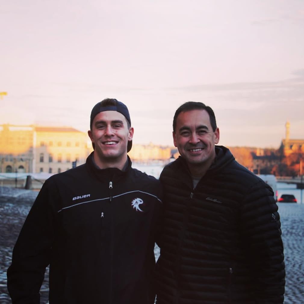 Kevin and his son together on a trip abroad at sunset